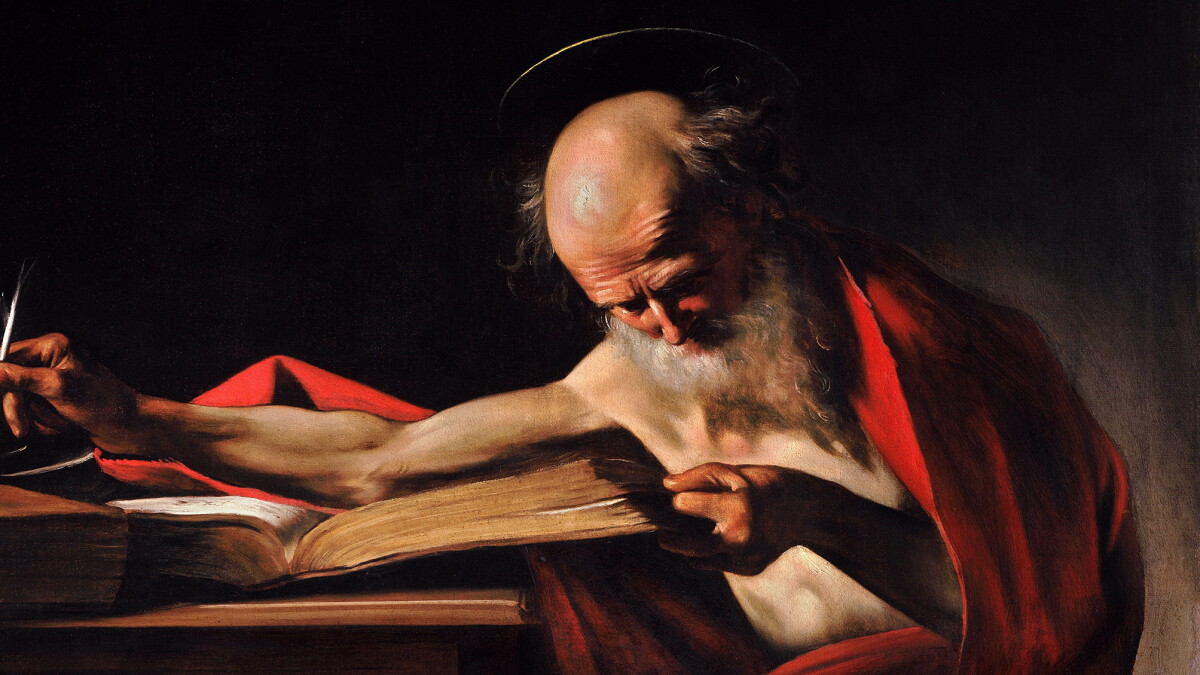 San Jerónimo estudia y escribe inclinado sobre un gran libro